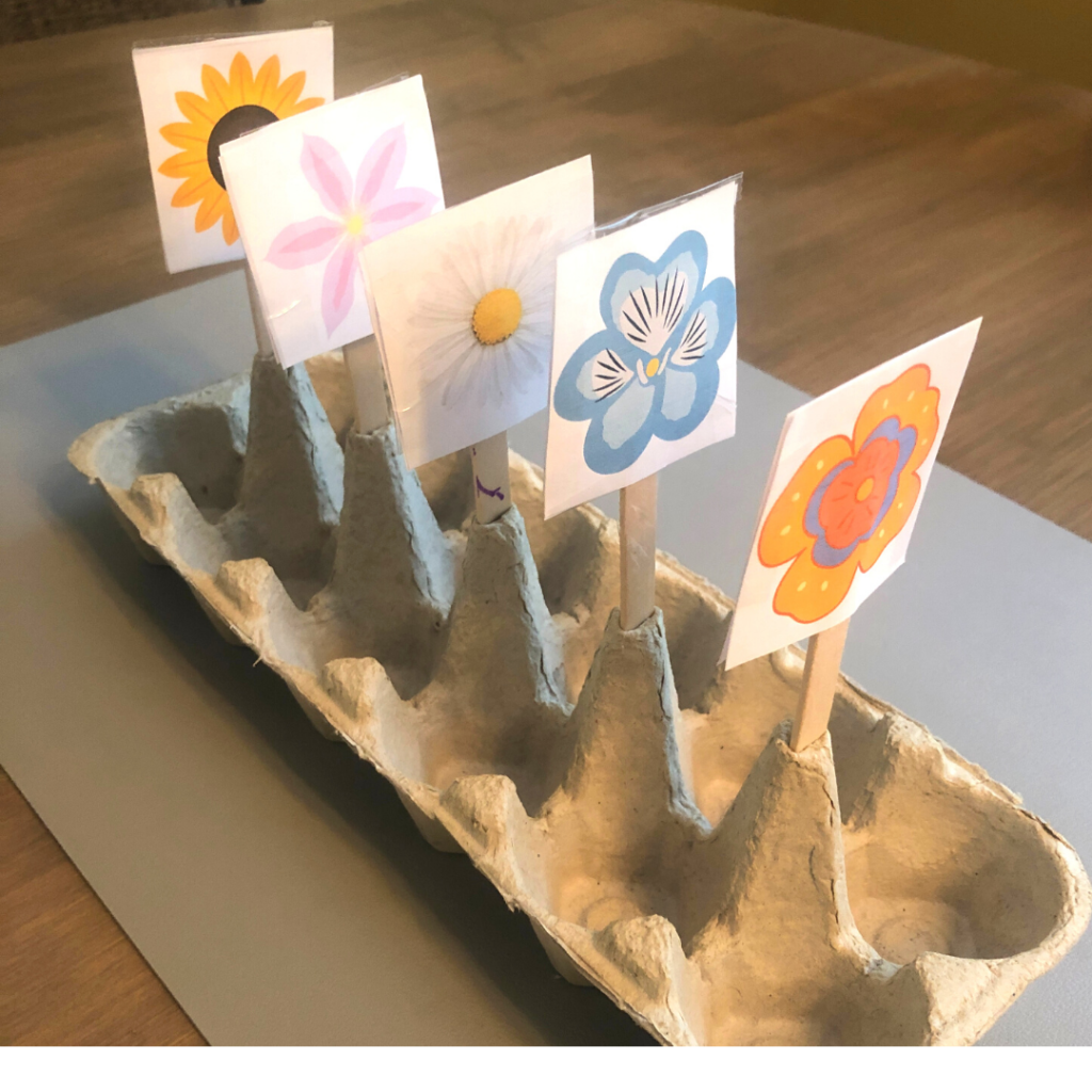 Flowers and a flower stand can be created from wooden craft sticks and the bottom of an egg carton. 